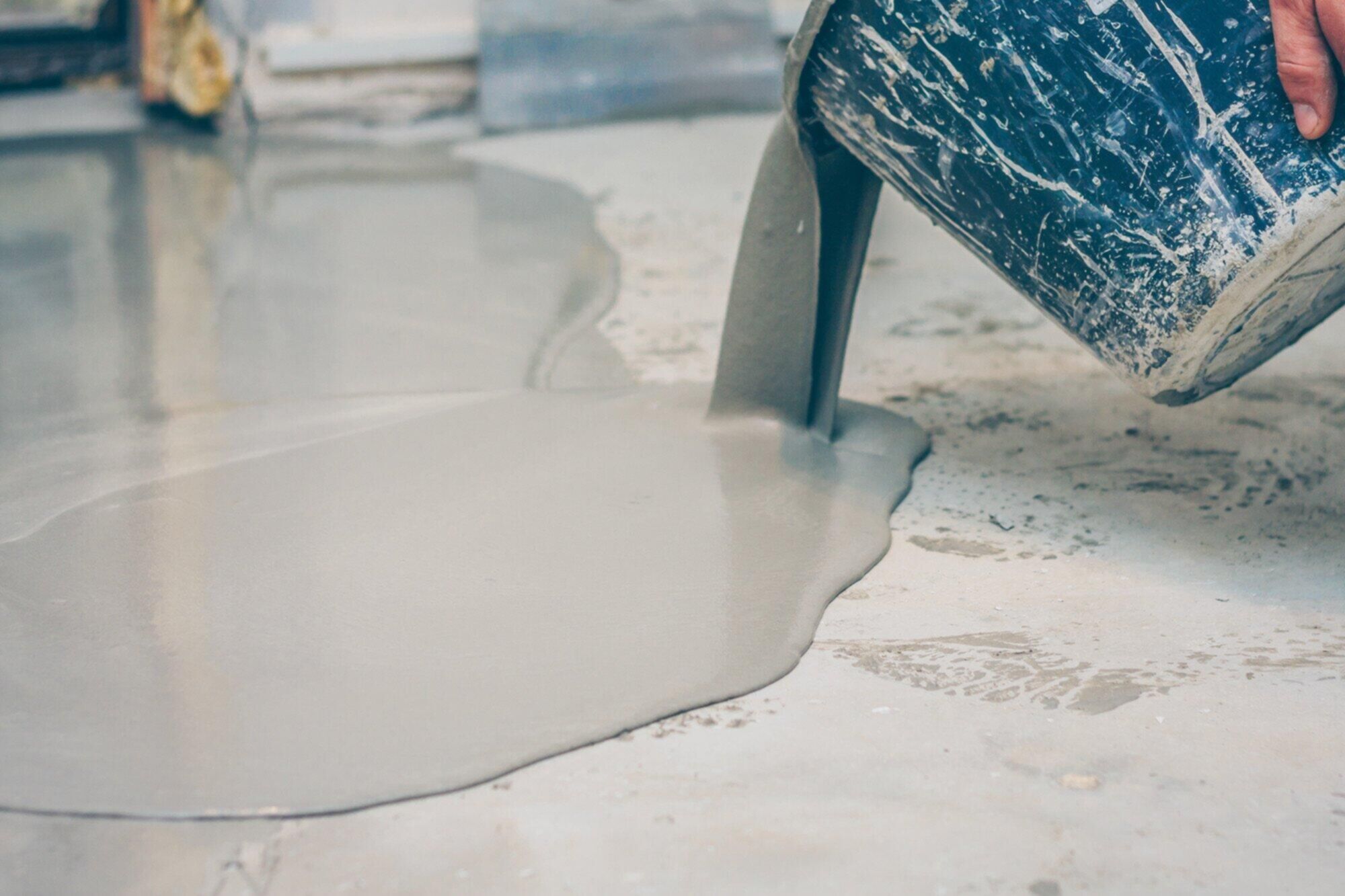 Installer applying garage floor epoxy coating